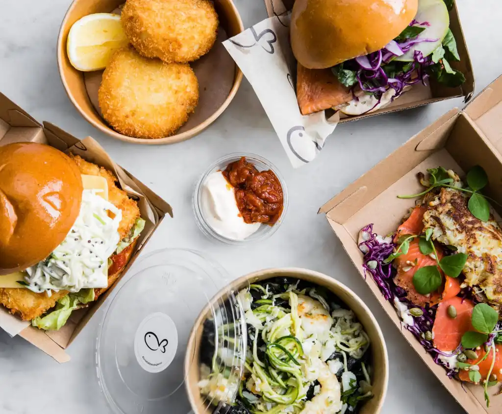 Take away food at Love Fish in Barangaroo including burgers and salad in cardboard takeaway containers