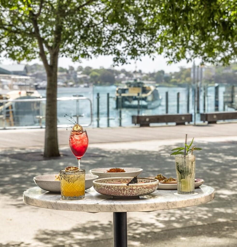A table with food and cocktails for two on the Barangaroo waterfront
