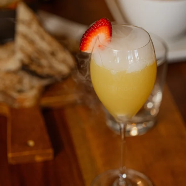 a love fish mimosa on a table of brunch food