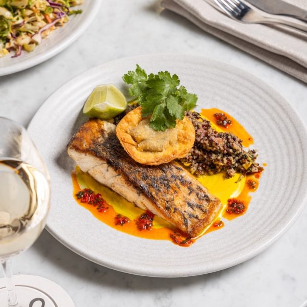 A plate with gilled barramundi, crab wonton and quinoa with saffron