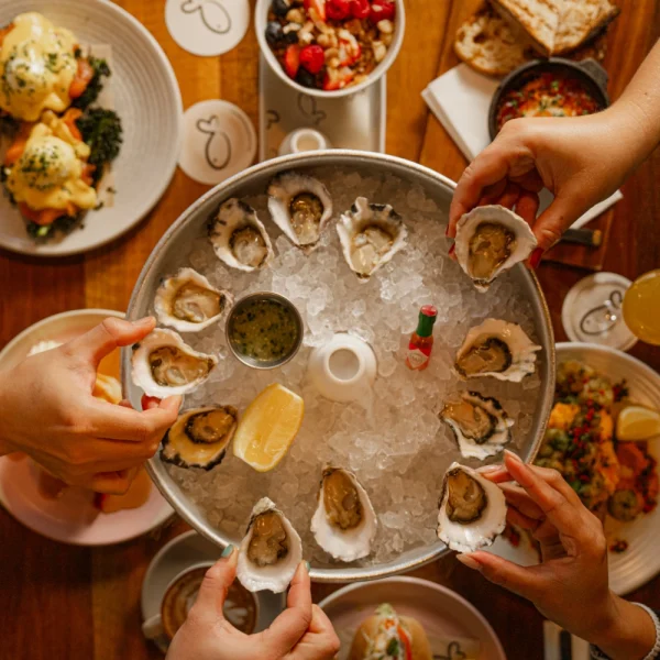a table sharing oysters at brunch